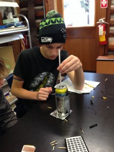 Billy is checking how the temperature of the water is changing as the peanut burns.